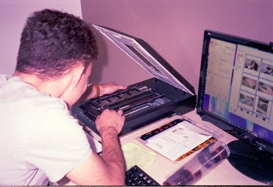 a man sitting at a desk using a laptop computer technical support, malware scan, software repair