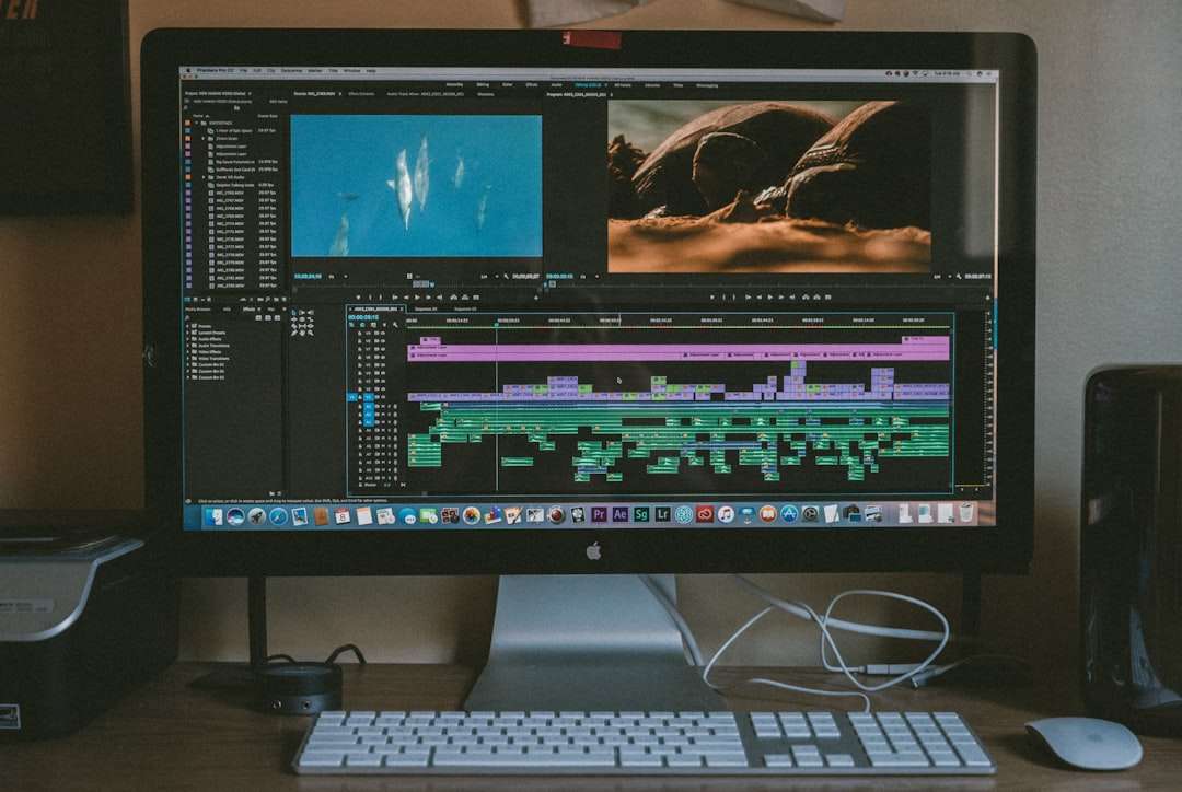 black iMac, Apple Magic Keyboard, and Apple Magic Mouse editing process, video timeline, video effects