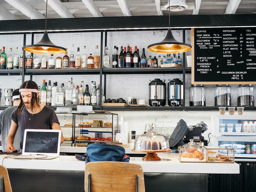two men standing near white kitchen island coffee shop interior website, modern cafe website design, weebly setup