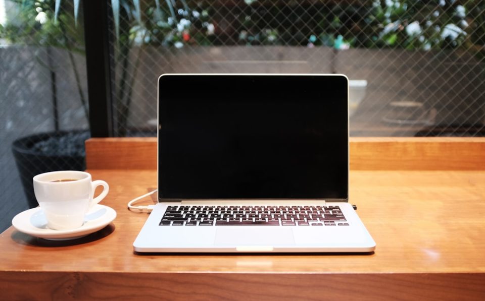 laptop computer beside coffee mug journalist anonymous secure location vpn laptop