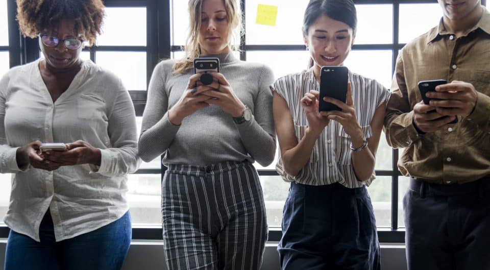 Group of diverse people using smartphones