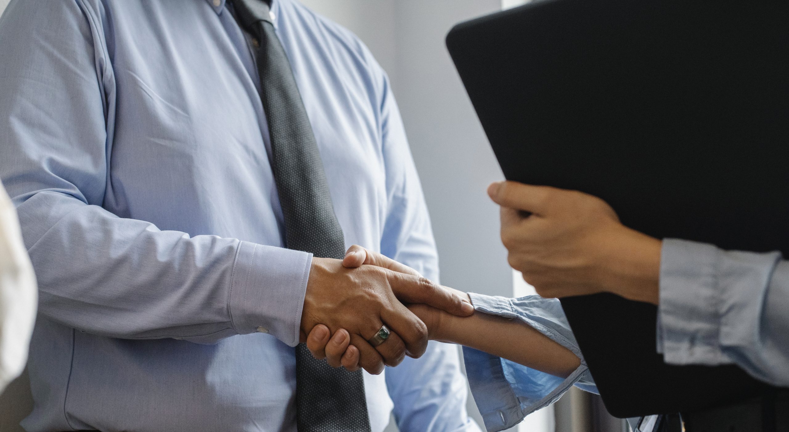 Man and woman shaking hands in office