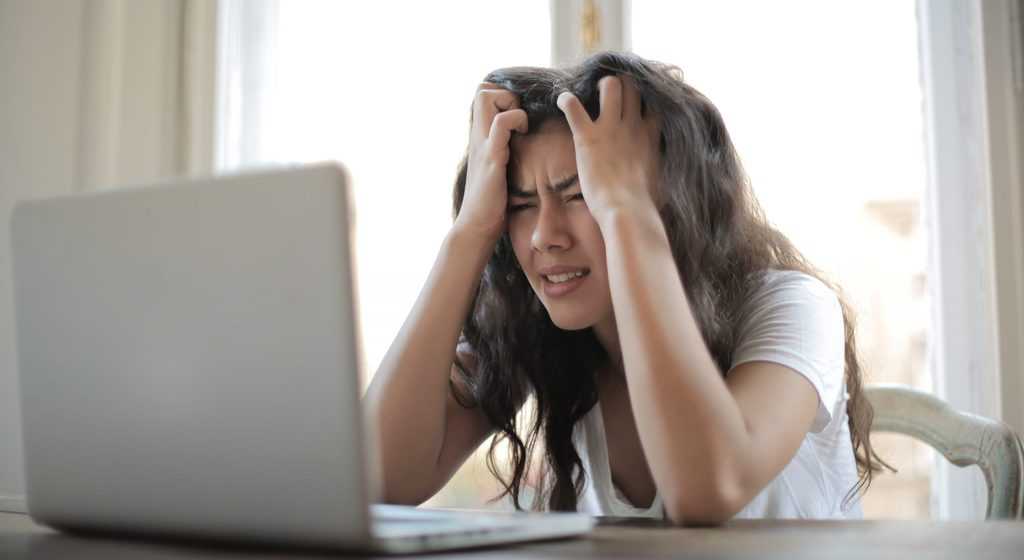 Woman in white shirt showing frustration