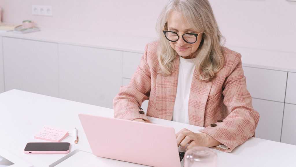 Woman in pink writing