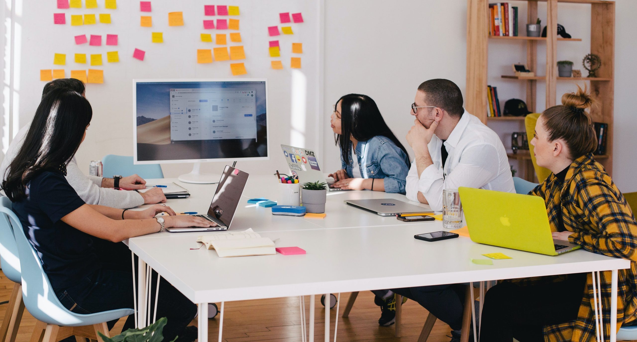 five person by table watching turned on white iMac