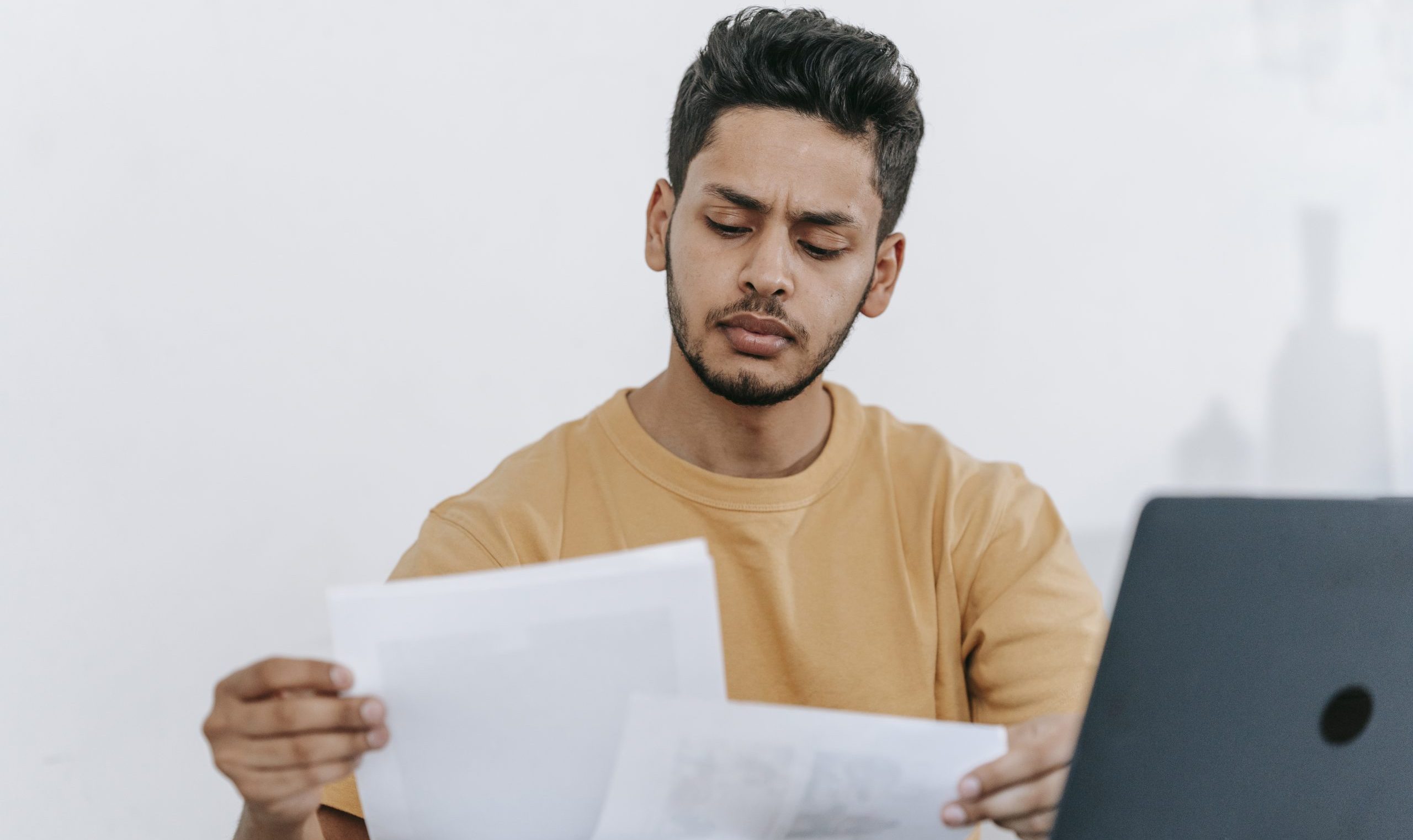 Man looking through documents at workplace