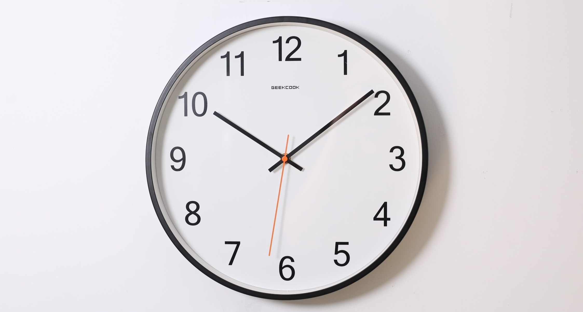 round analog wall clock pointing at 10:09