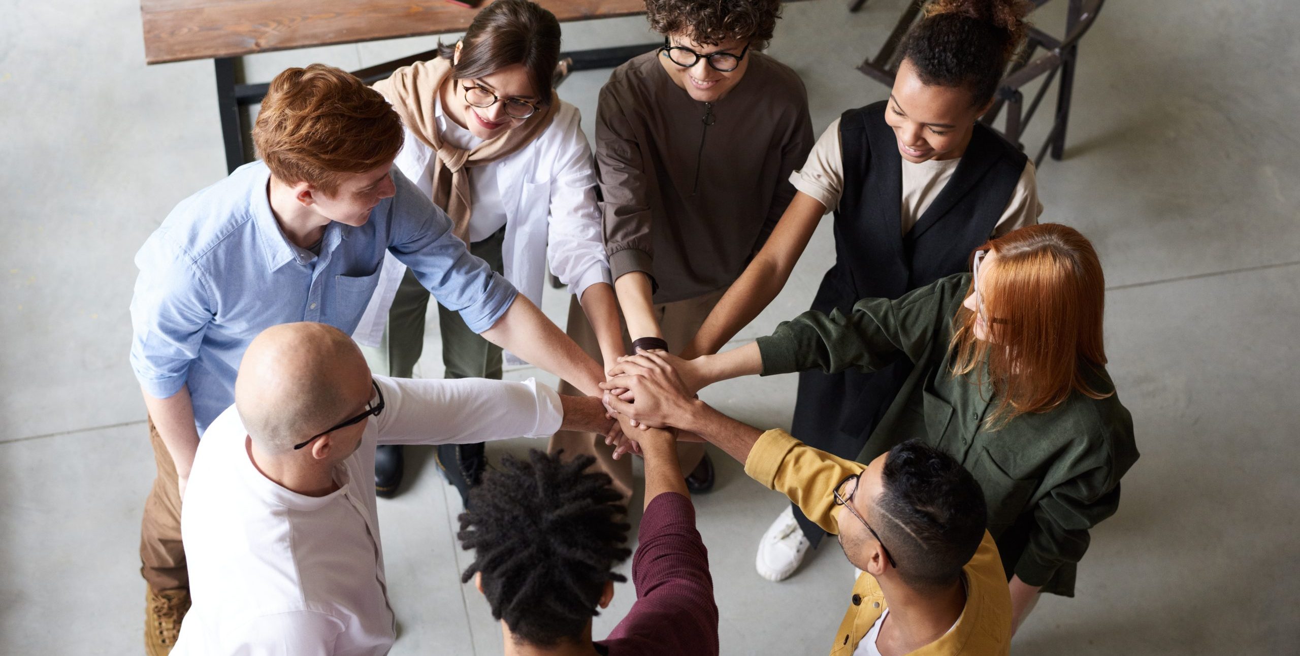 Photo of people holding each other s hands