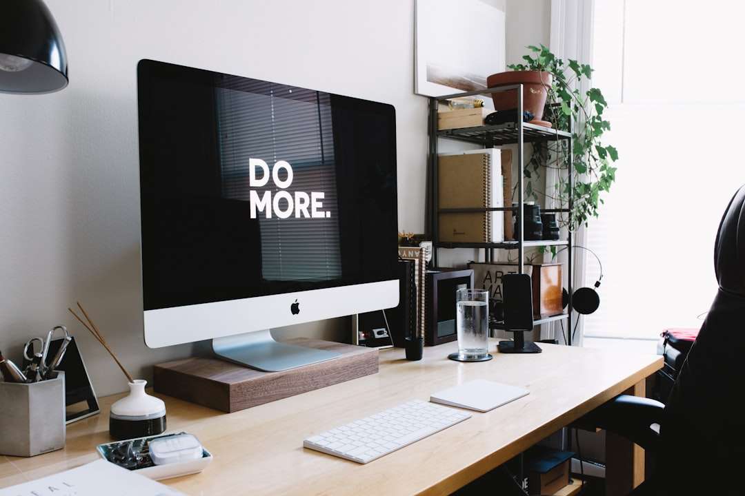 silver iMac with keyboard and trackpad inside room capcut desktop interface, drag and drop, video editing