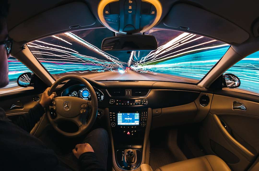 time lapse photography of man riding car self driving truck logistics gps