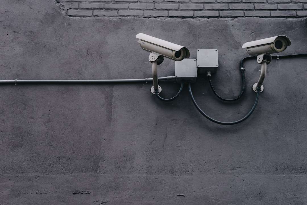 two bullet surveillance cameras attached on wall wifi campus network security