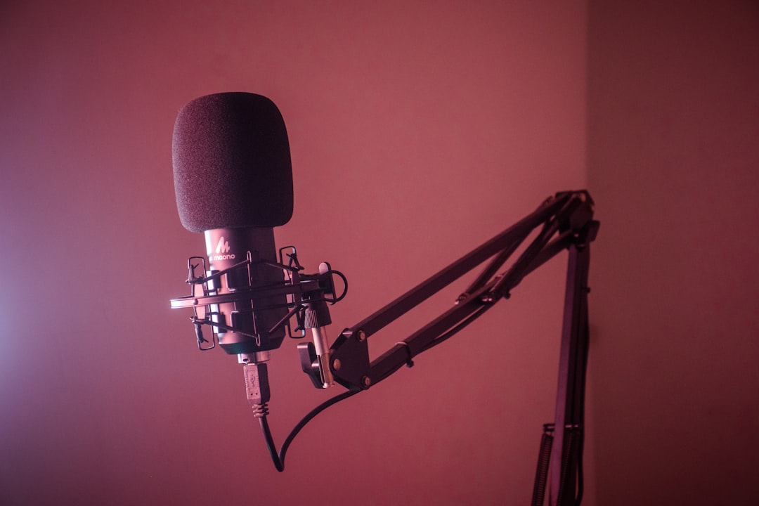 a camera on a tripod voice recording studio microphone soundproof booth audio waveform