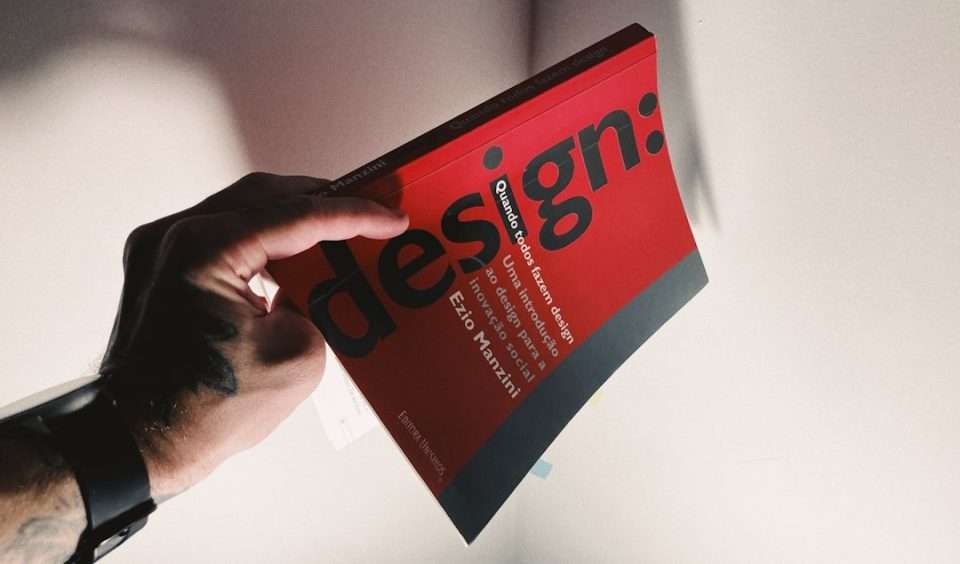 a person holding a book in their hand canva design, pamphlet layout, small business flyer