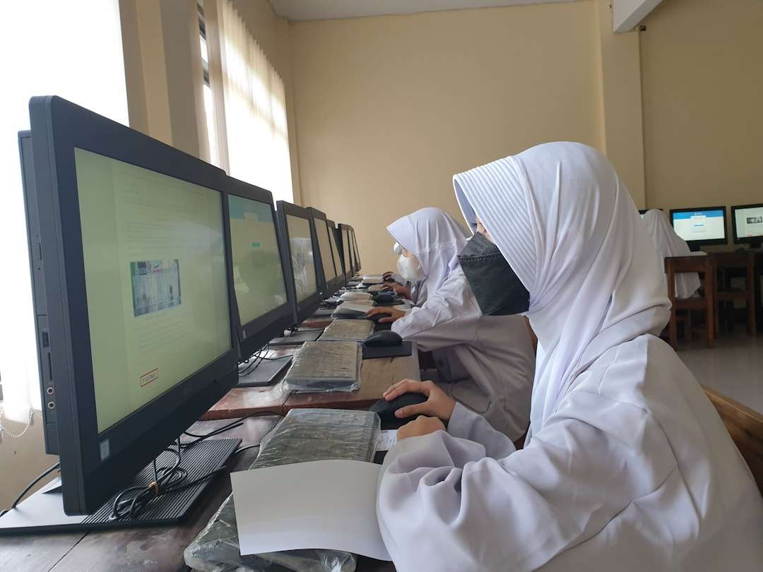 a couple of people working on computers kajabi dashboard online course creation
