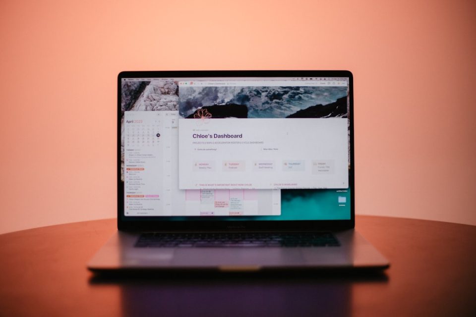 a laptop computer sitting on top of a wooden table domain search interface laptop, website name ideas screen, modern workspace desk