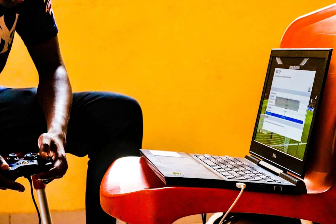 a man sitting in a chair with a laptop on his lap webinar registration form laptop user