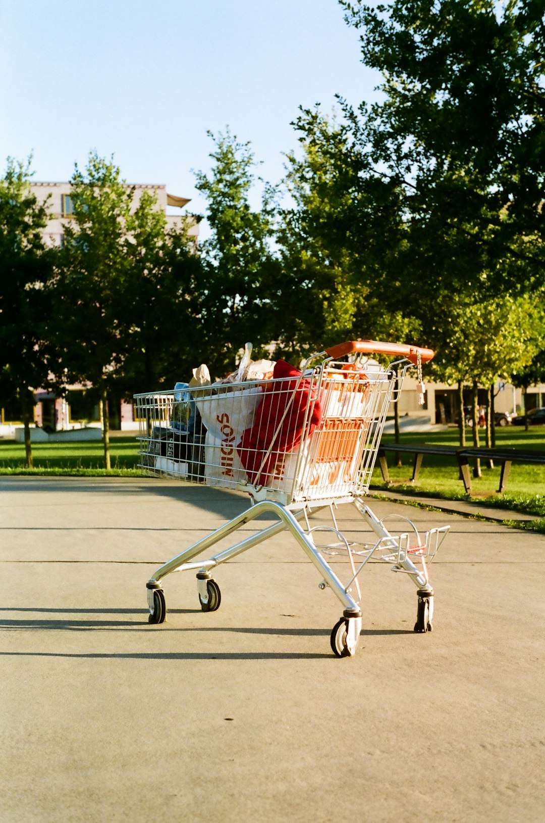 a shopping cart sitting on the side of a road contactless payment, mobile transaction, shopping cart