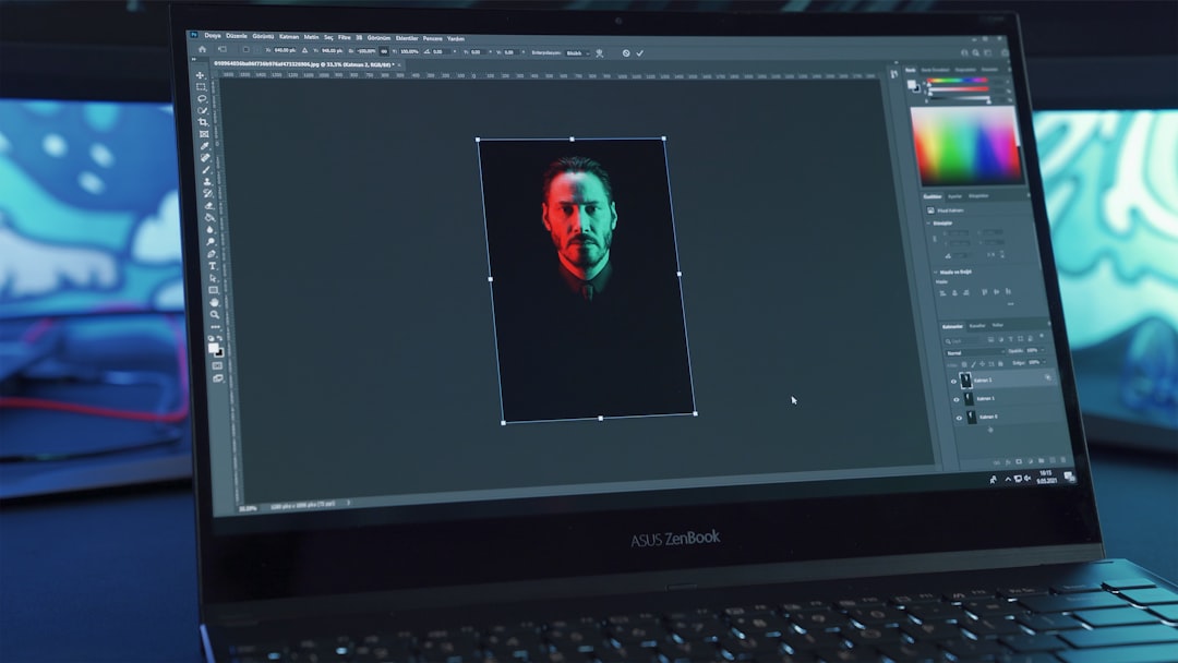 black lenovo laptop computer turned on displaying man in red shirt logo design interface laptop screen, color palette options, typography selection panel