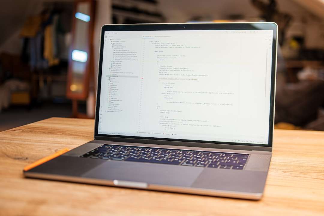 Laptop displaying lines of code on screen laptop website building template design