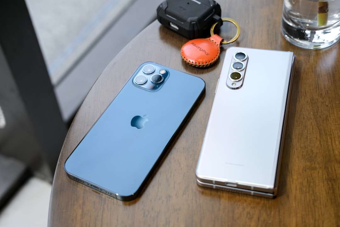 two cell phones sitting on top of a wooden table galaxy a35, galaxy s23, smartphone comparison