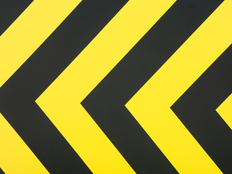 a close up of a yellow and black arrow sign logo grid layout design alignment