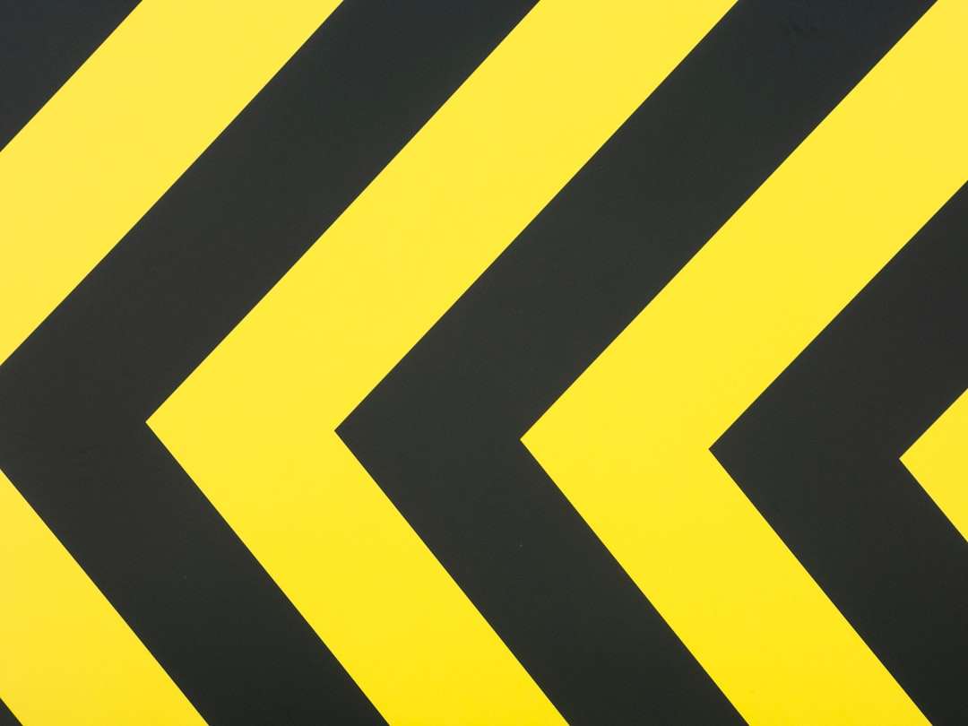 a close up of a yellow and black arrow sign logo grid layout design alignment