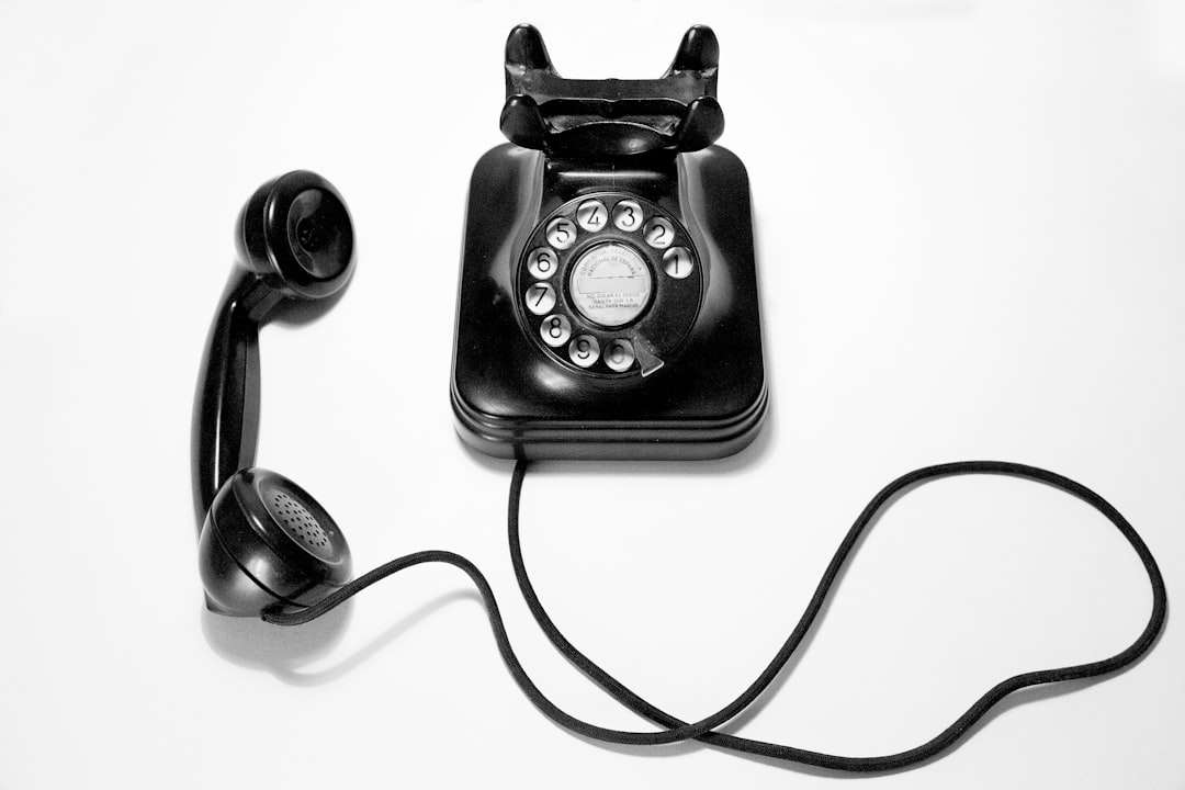 black rotary dial phone on white surface sales technology, outbound calls, team talking