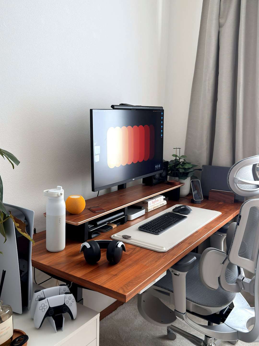 Modern desk setup with computer and gaming accessories. home office desk planner laptop coffee natural light