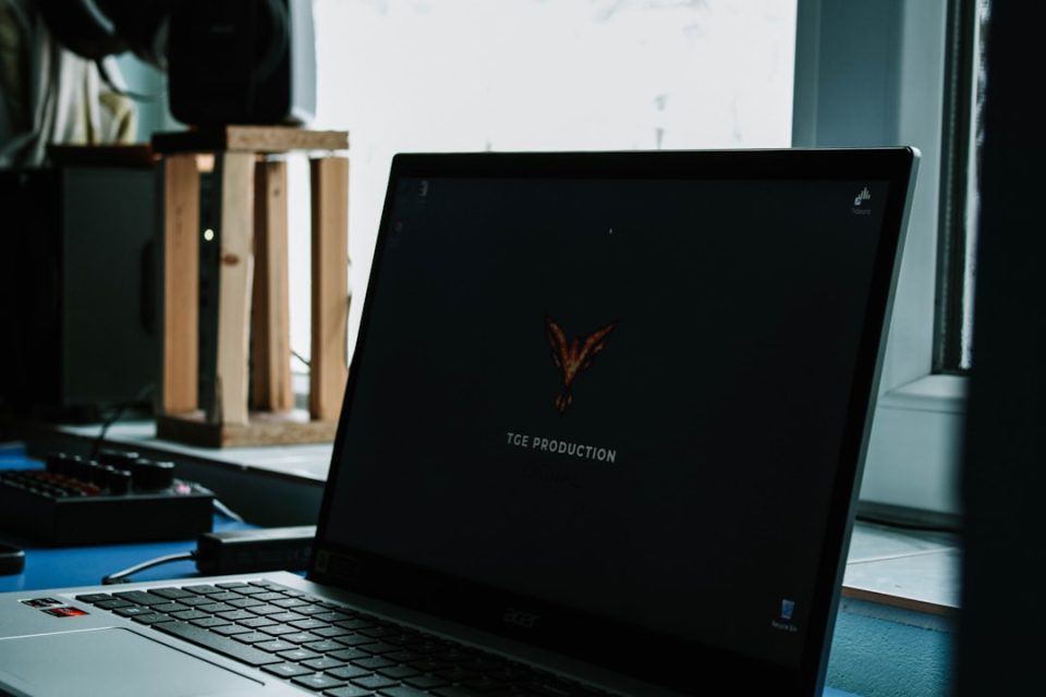 a laptop computer sitting on top of a desk downloading software installer, reinstalling program on laptop, gaming launcher installation screen