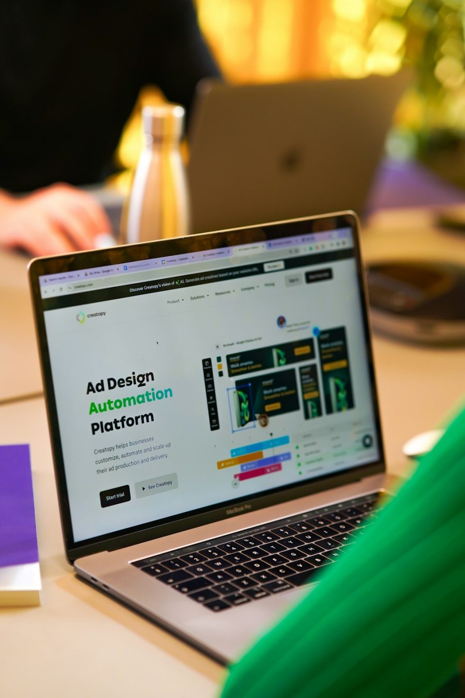 a laptop computer sitting on top of a table brand guidelines document, marketing team collaboration, digital branding assets on screen