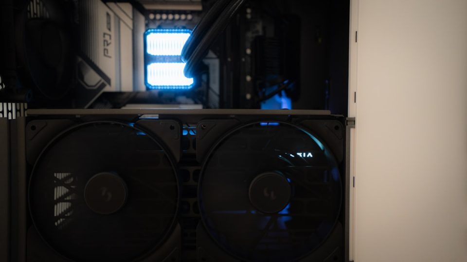 Inside of a computer tower with fans. dusty pc fan interior, heat sink dust buildup, computer cleaning
