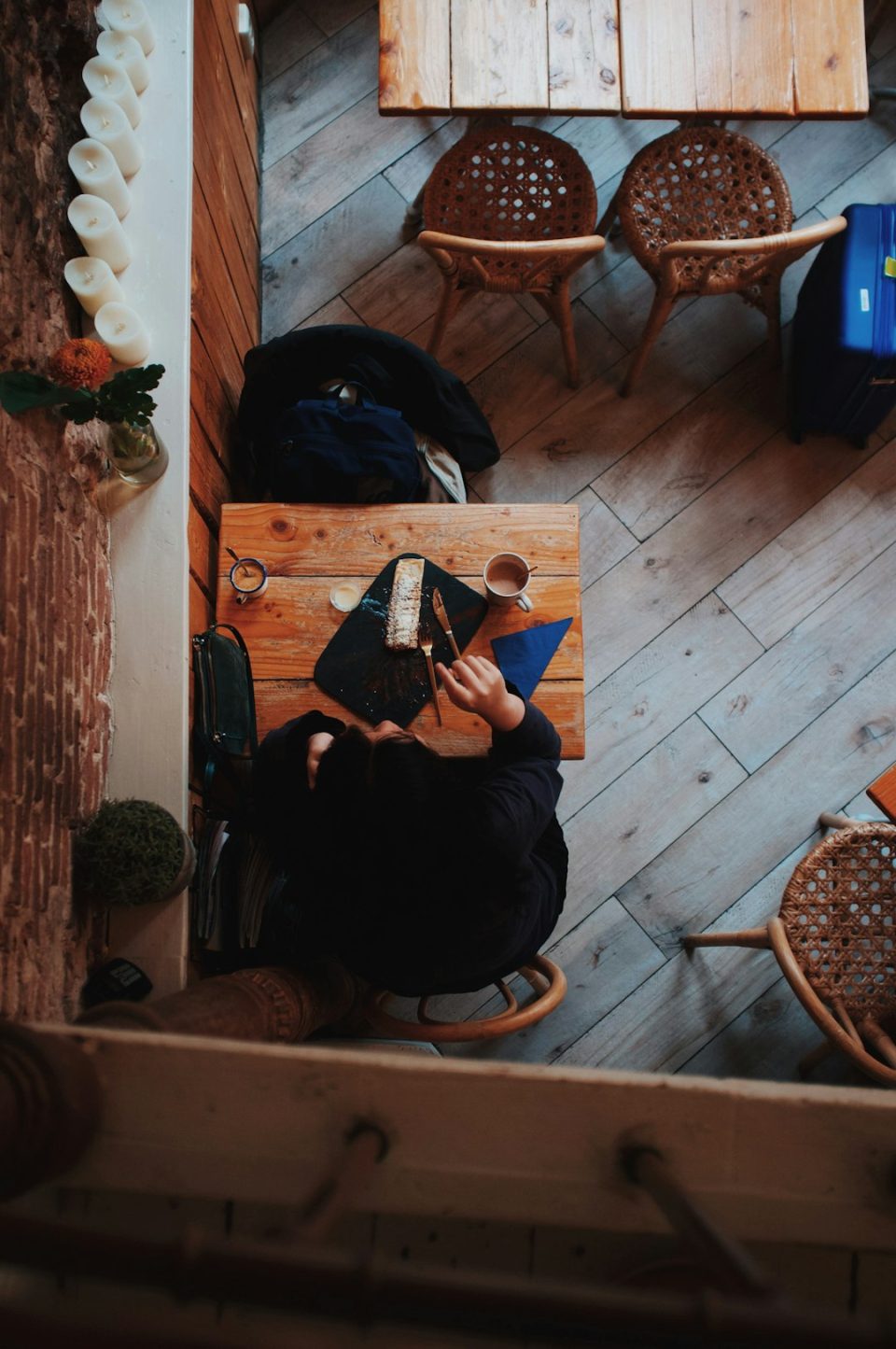 a person sitting at a table using a laptop computer small business owner working on smartphone in cafe, digital receipt capture, freelancer workspace with notebook and coffee