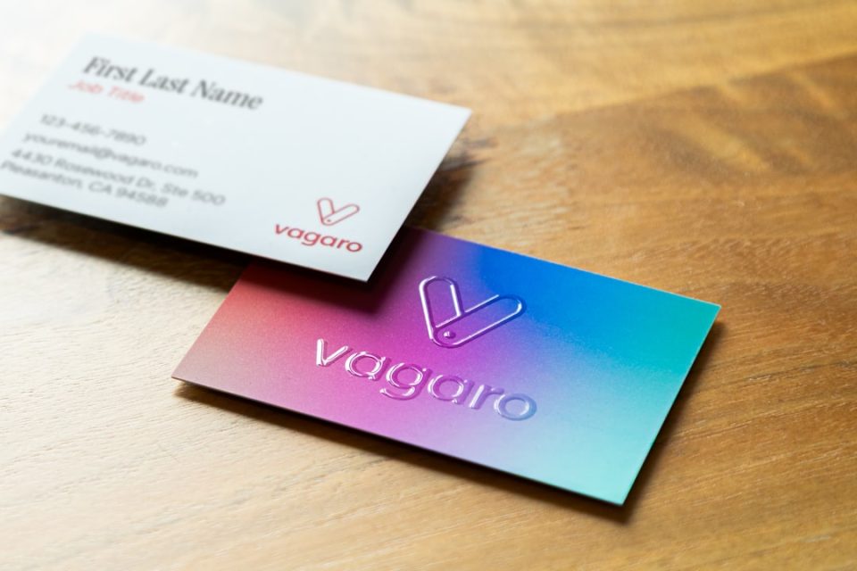 Two business cards on a wooden surface. brand identity mockup, business cards website social media, cohesive branding